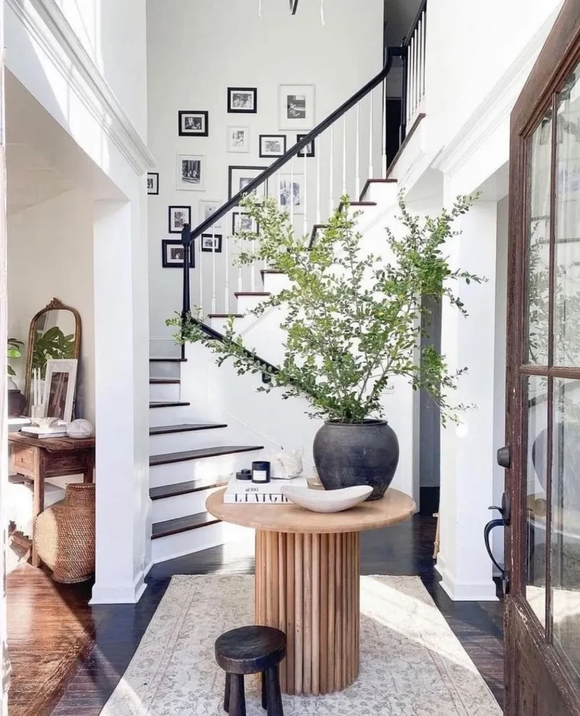 Bright Staircase Entry with a Sculptural Table