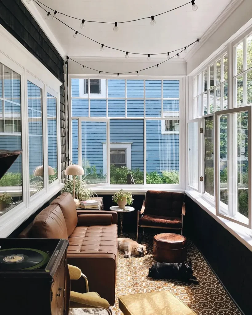 Sunroom with String Lights and Leather Sofa
