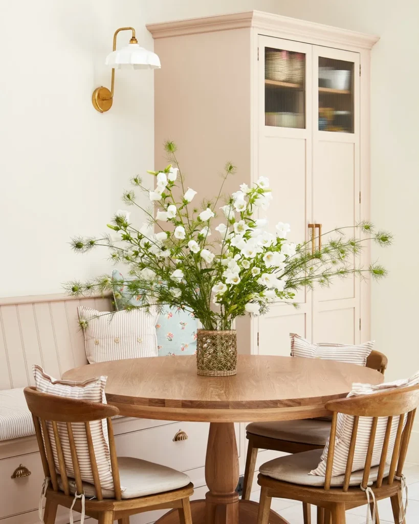 Blush Breakfast Nook with a Round Wood Table