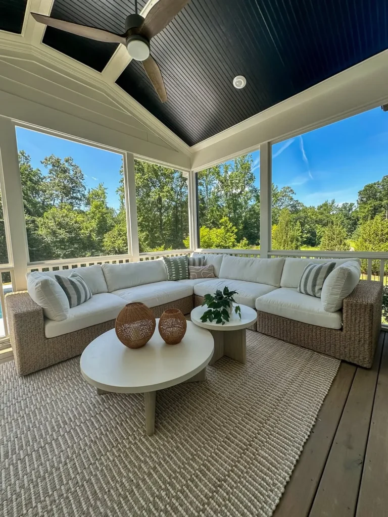 Modern Screened Porch with White Sectional and Black Ceiling