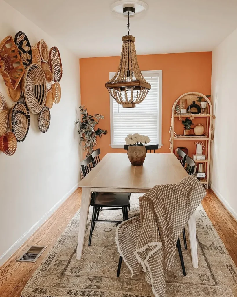 Orange Accent Dining Space With Woven Wall Decor