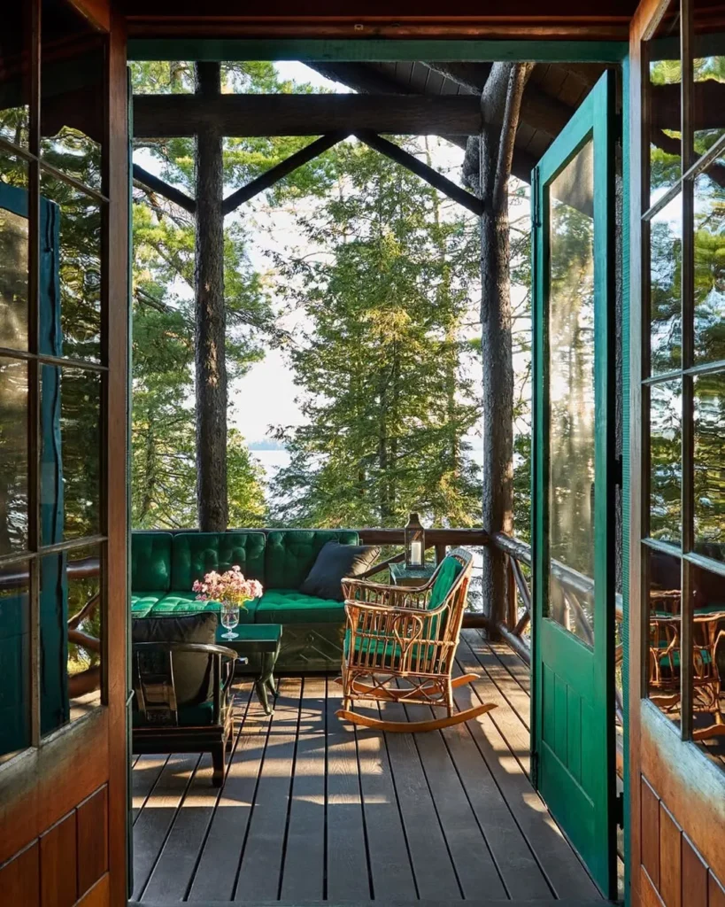 Rustic Screened Porch with Green Sofa and Lake View