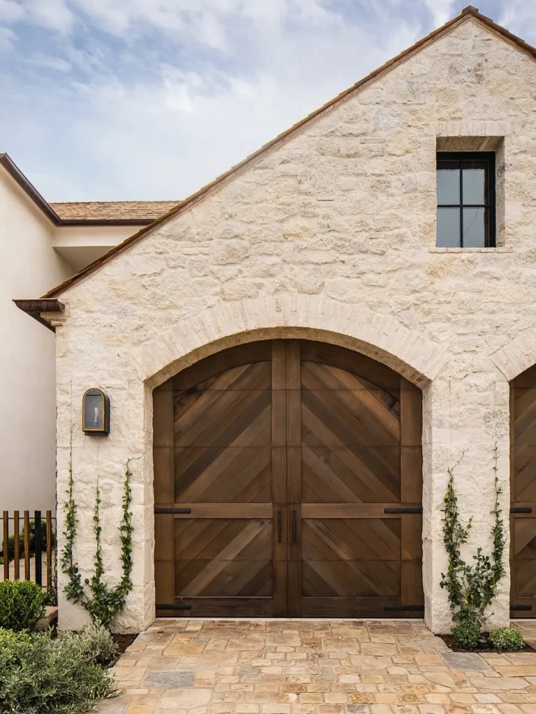 Arched Wood Garage Doors for a Stone House Exterior
