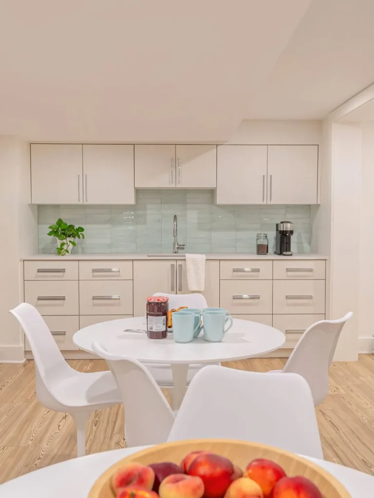 Bright Basement Kitchenette With Mint Tile Backsplash