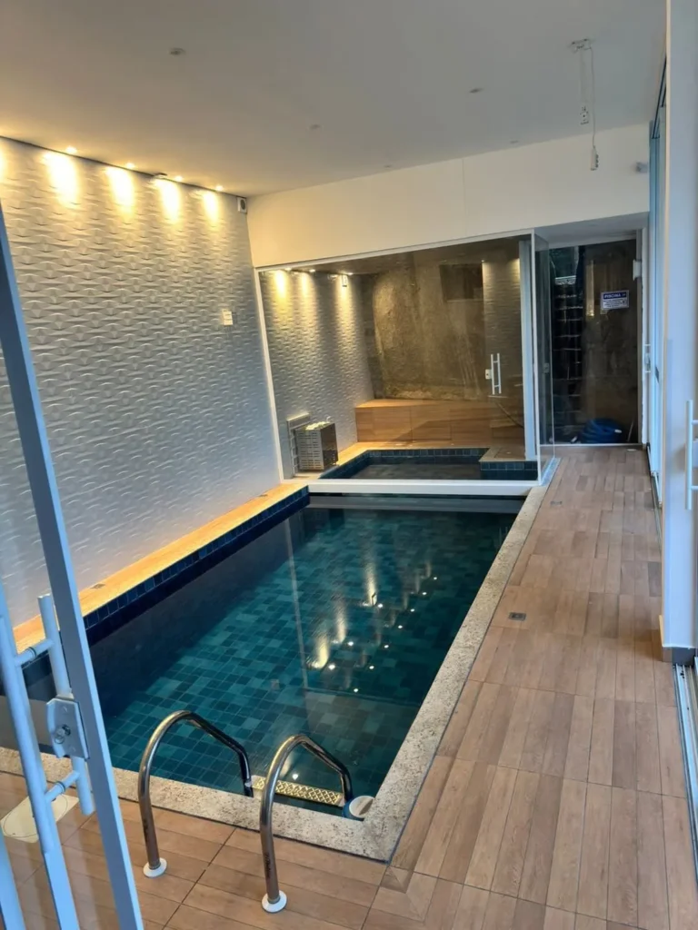 Compact Indoor Pool With Textured Wall Lighting