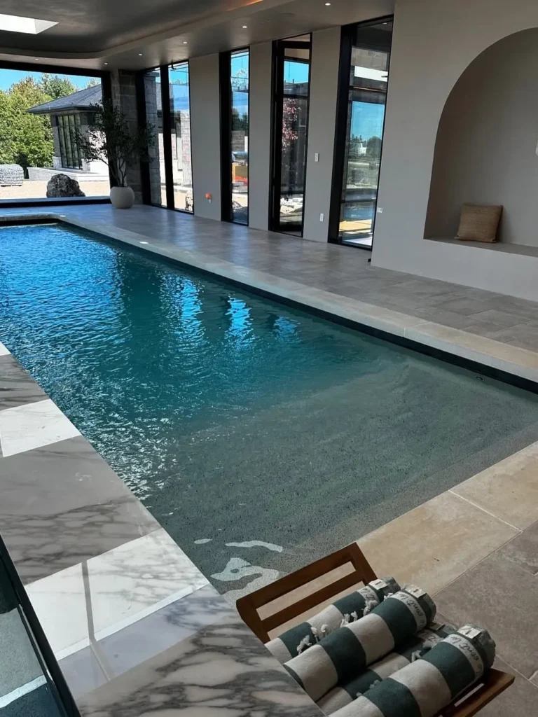 Contemporary Indoor Pool With Marble Surrounds