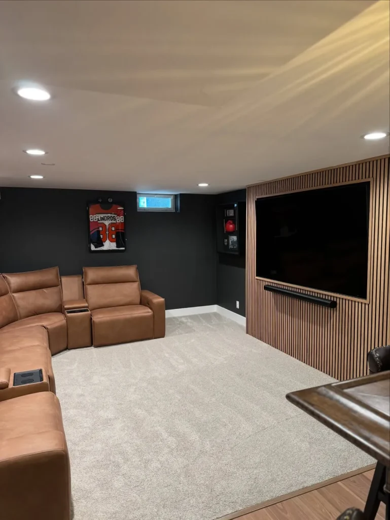 Dark Basement Home Theater With Slat Wood TV Wall