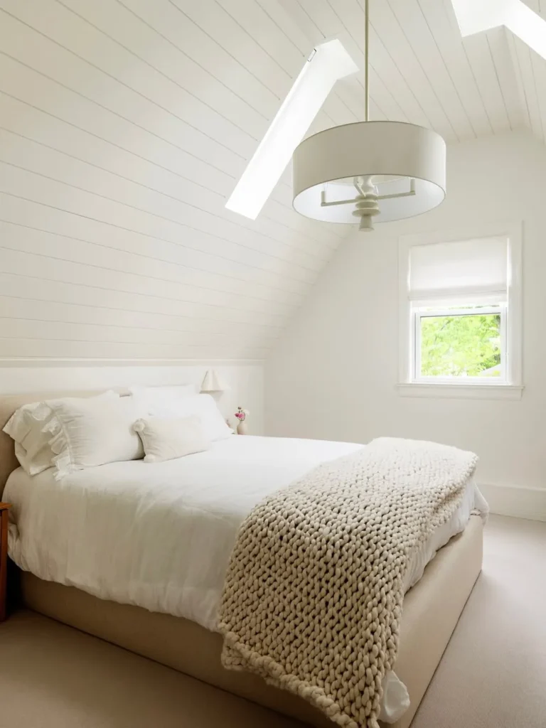 White Attic Bedroom With Shiplap Walls and Soft Textures