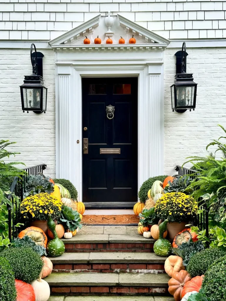 Classic Black Door Framed With Autumn Planters