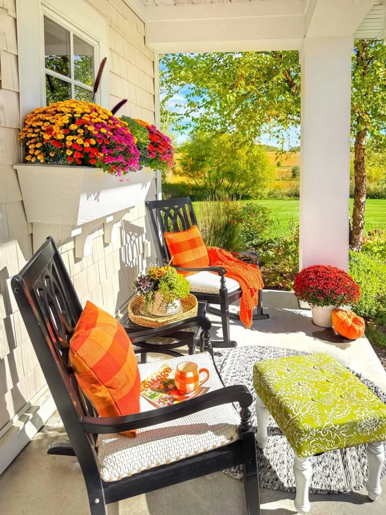 Colorful Front Porch With Fall Mums and Rocking Chairs