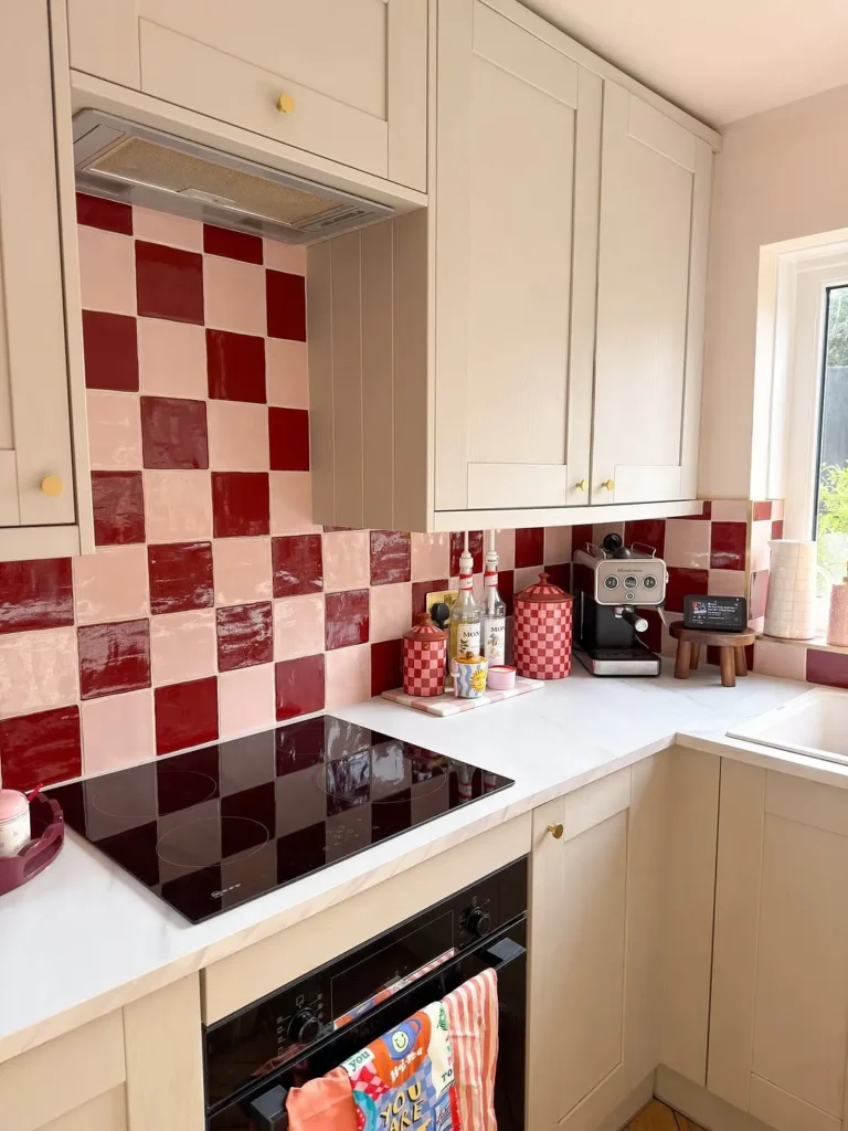 Cream Cabinets with Cherry Red Checkerboard Tiles
