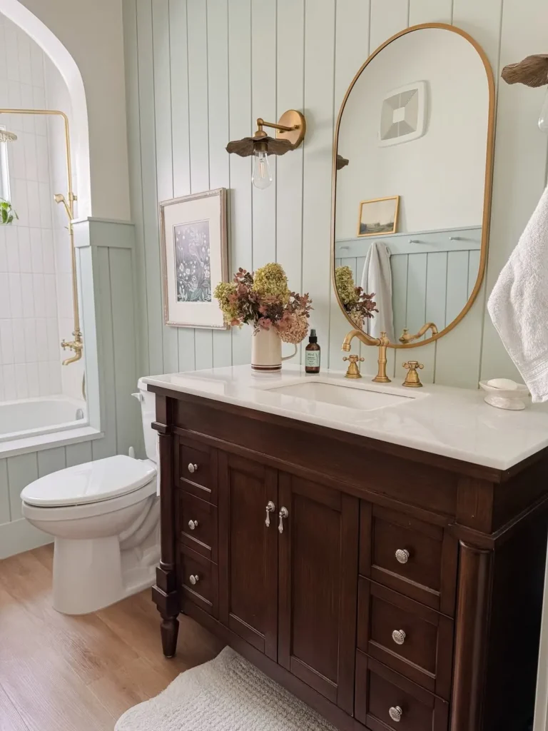 Sage Green Vertical Wainscoting With a Dark Wood Vanity