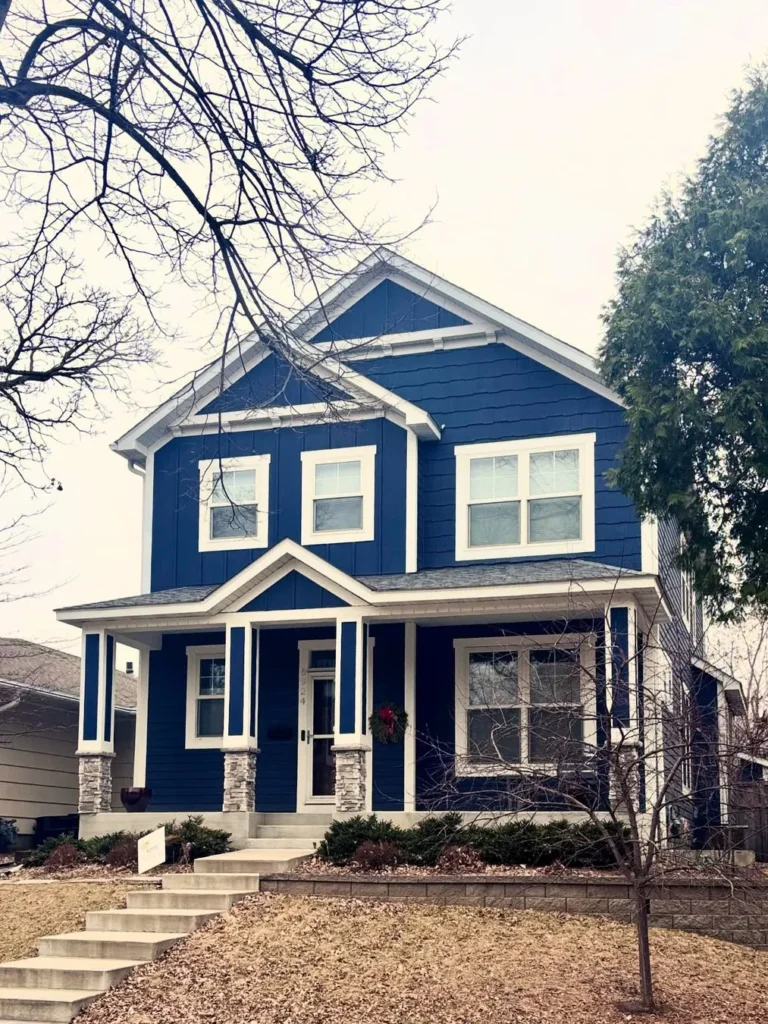 Two-Story Dark Blue Home With Covered Front Porch