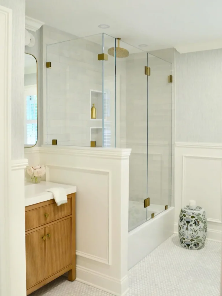 White Picture Frame Wainscoting Around a Glass Shower
