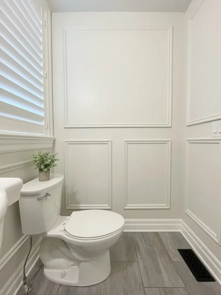 White Picture Frame Wainscoting for a Small Bathroom
