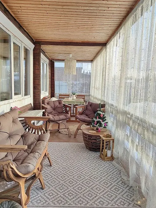 Sheer-Curtain Porch With Cozy Seating