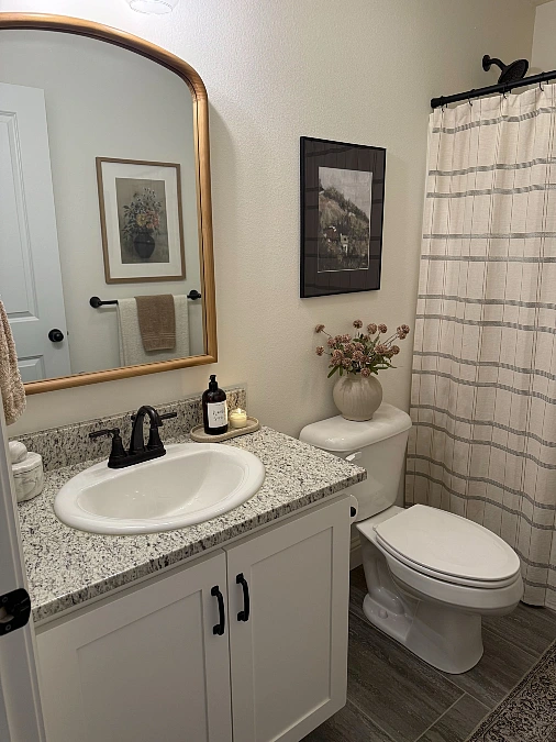 Warm Wood Mirror with Soft Plaid Textiles